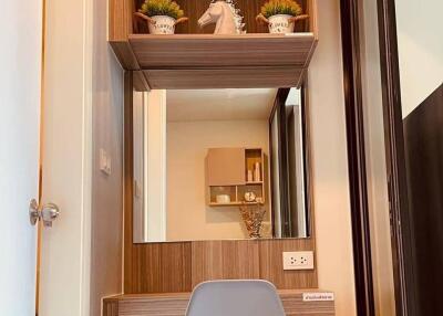 Stylish bedroom vanity with wooden shelves and modern chair