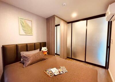 Comfortable and modern bedroom with frosted glass sliding door and cozy bed