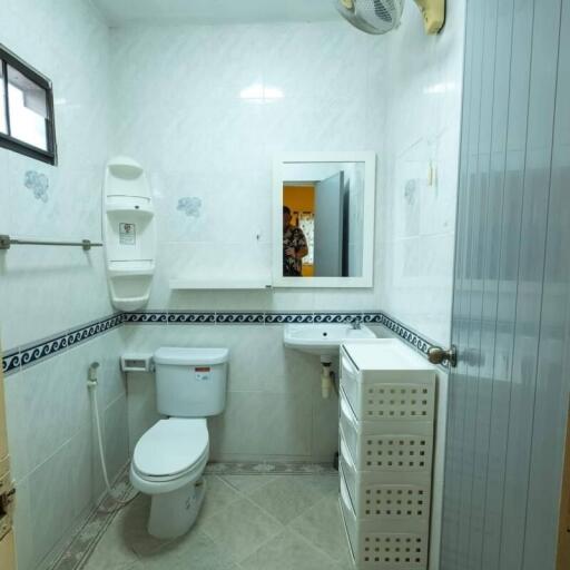 Clean and well-lit bathroom with essential amenities