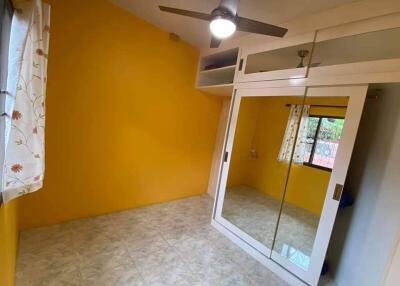 Bedroom with yellow walls and wardrobe