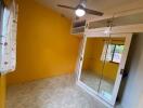 Bedroom with yellow walls and wardrobe