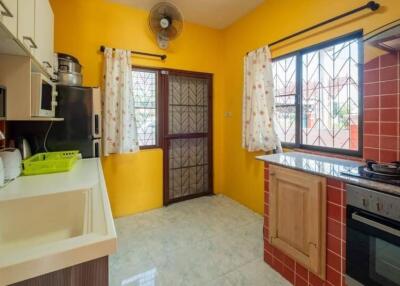 Bright kitchen with yellow walls and tiled backsplash