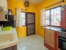 Bright kitchen with yellow walls and tiled backsplash