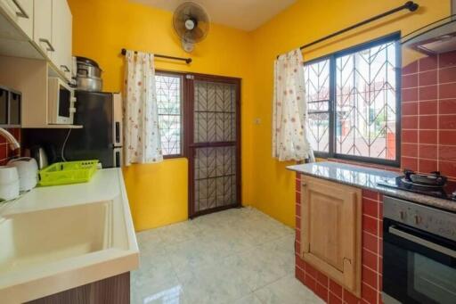 Bright kitchen with yellow walls and tiled backsplash