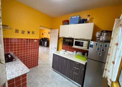 Modern kitchen with yellow walls and red tile backsplash