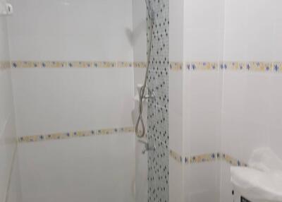 Modern bathroom with shower and tiled walls