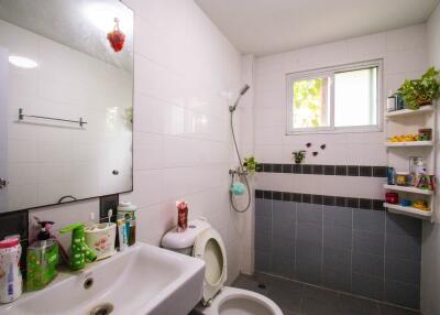 Modern bathroom with shower and wall shelves