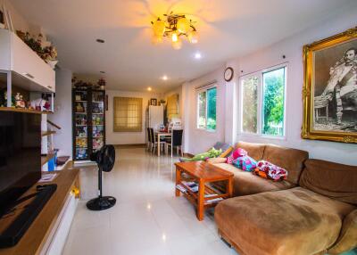 Spacious living room with large windows and comfortable seating