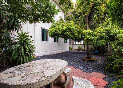 Lush garden with stone table and seating area