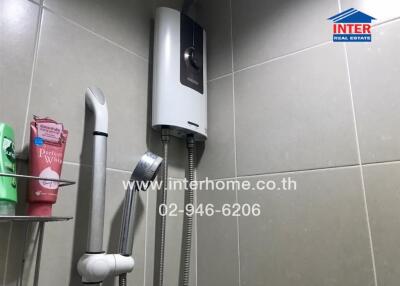 Shower area with water heater and toiletries