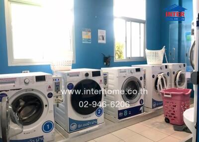 Laundry room with multiple washing machines