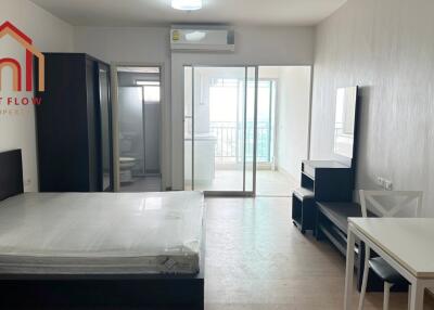 Spacious bedroom with bed, wardrobe, and access to balcony