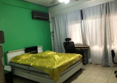 Bedroom with green walls and yellow bedding