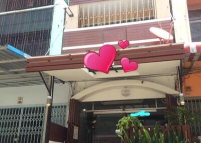 Exterior view of a multi-story building with plants and hearts decorations