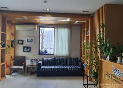 A cozy living room with sofa and bookshelf