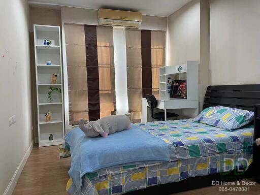 Cozy bedroom with single bed and study area