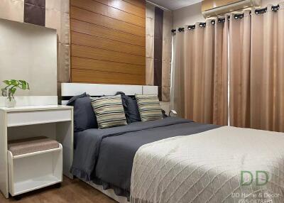 Modern bedroom with a double bed, side table, and air conditioning