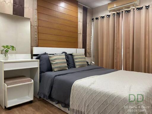 Modern bedroom with a double bed, side table, and air conditioning