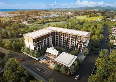 Aerial view of a modern residential building surrounded by greenery and scenic landscape