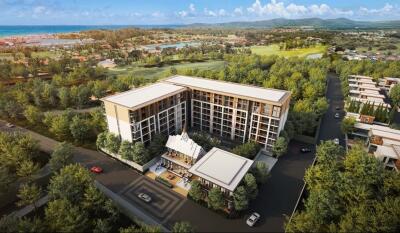 Aerial view of a modern residential building surrounded by greenery and scenic landscape