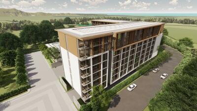 Aerial view of modern apartment building with greenery and parking