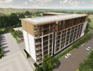 Aerial view of modern apartment building with greenery and parking