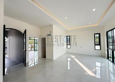 Modern living room with large windows and tiled floor