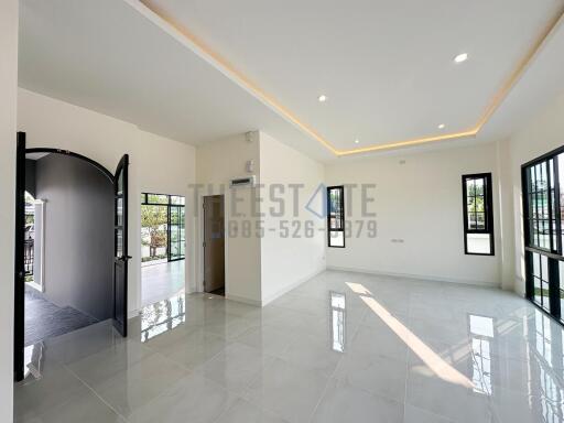 Modern living room with large windows and tiled floor