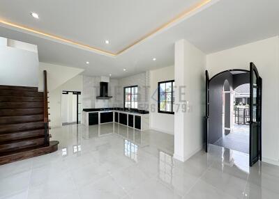 Spacious main living area with modern kitchen and staircase