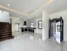 Spacious main living area with modern kitchen and staircase