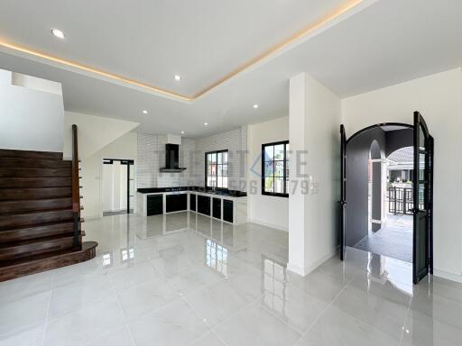 Spacious main living area with modern kitchen and staircase