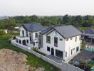 Aerial view of a modern multi-story residential building with landscaped surroundings