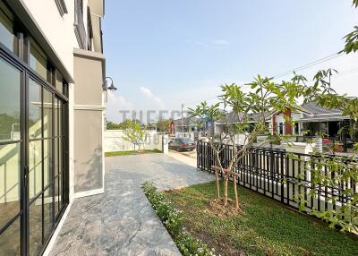 Spacious side view of a modern property with gardening area