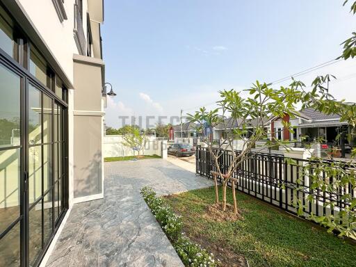 Spacious side view of a modern property with gardening area