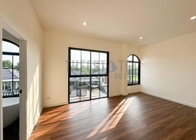 Spacious bedroom with large windows and natural light