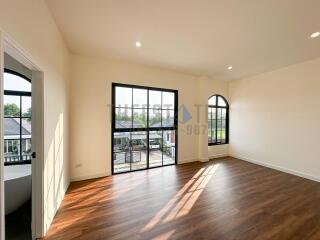 Spacious bedroom with large windows and natural light