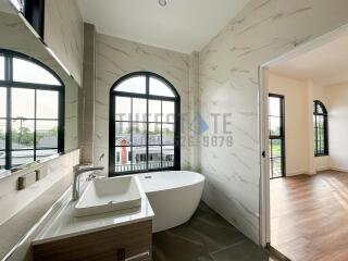 Modern bathroom with bathtub and scenic window view