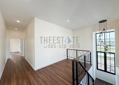 Bright hallway with modern light fixture and wooden flooring