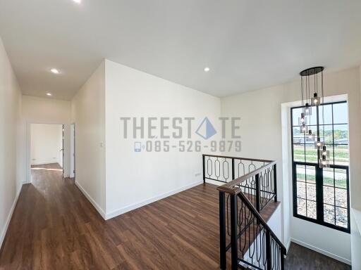 Bright hallway with modern light fixture and wooden flooring