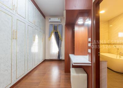 Spacious bedroom with a contemporary design, large wardrobes, and an adjoining bathroom