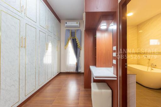 Spacious bedroom with a contemporary design, large wardrobes, and an adjoining bathroom