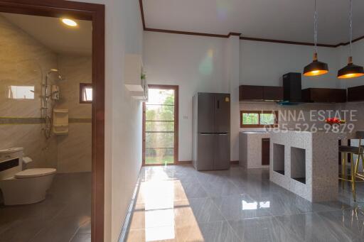 Modern kitchen and dining area with adjoining bathroom