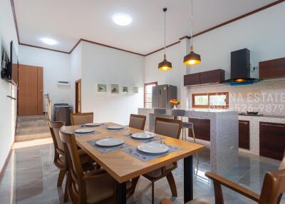 Modern kitchen and dining area with wooden accents