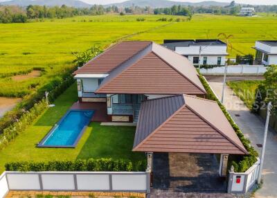 Aerial view of a modern house with a pool and backyard