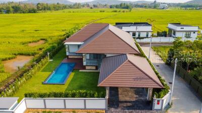 Aerial view of a modern house with a pool and backyard