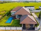 Aerial view of a modern house with a pool and backyard