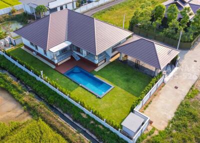 Aerial view of a modern house with a pool