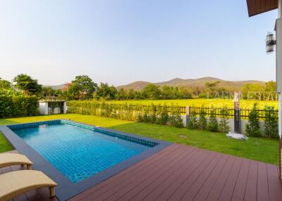 Outdoor area with swimming pool and spacious lawn