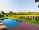 Outdoor area with swimming pool and spacious lawn