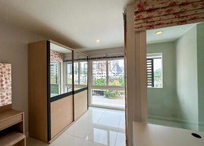 Bright and spacious bedroom with large windows.